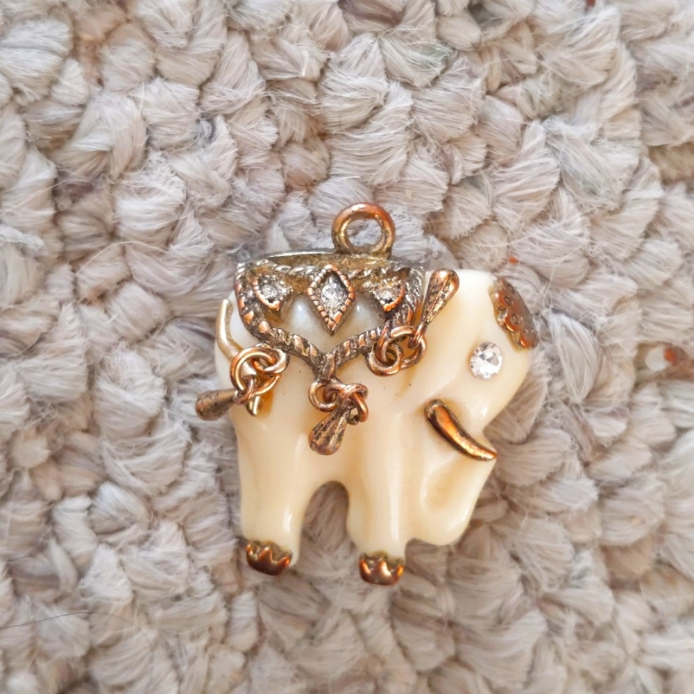 Ivory colored pendant elephant.